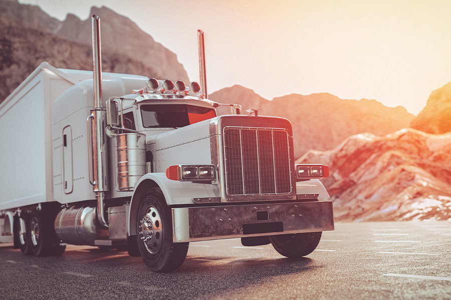 Specialized Business Insurance - Truck Driving Down the Freeway with Sun Shining at Dusk